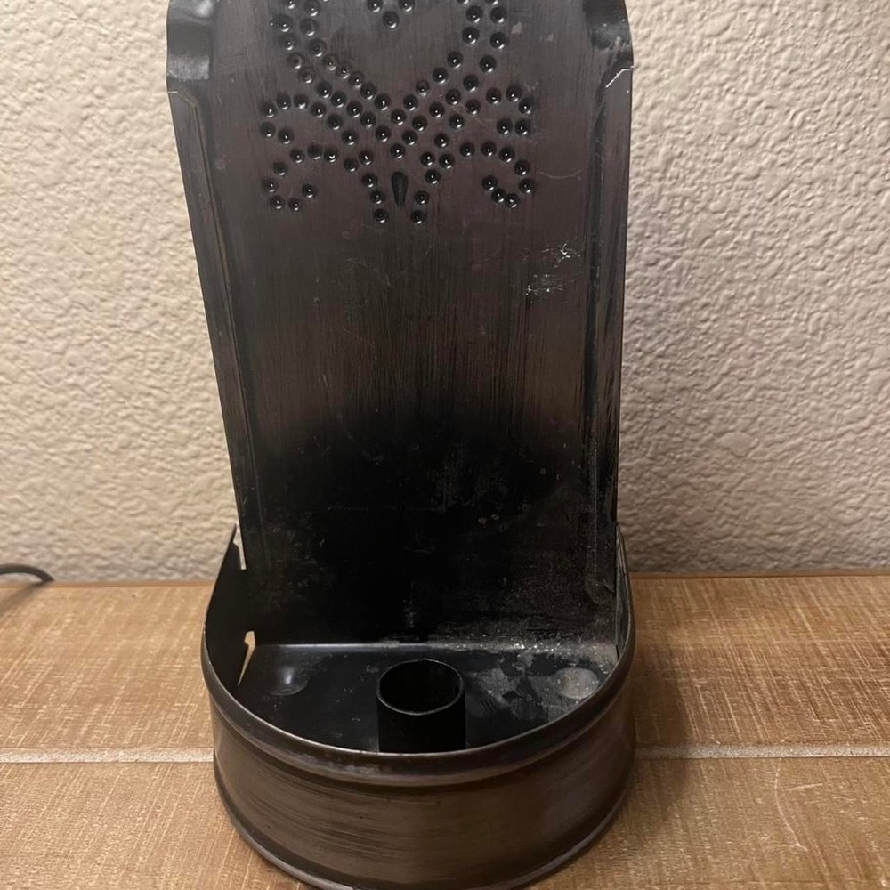Black metal candle holder with a unique design